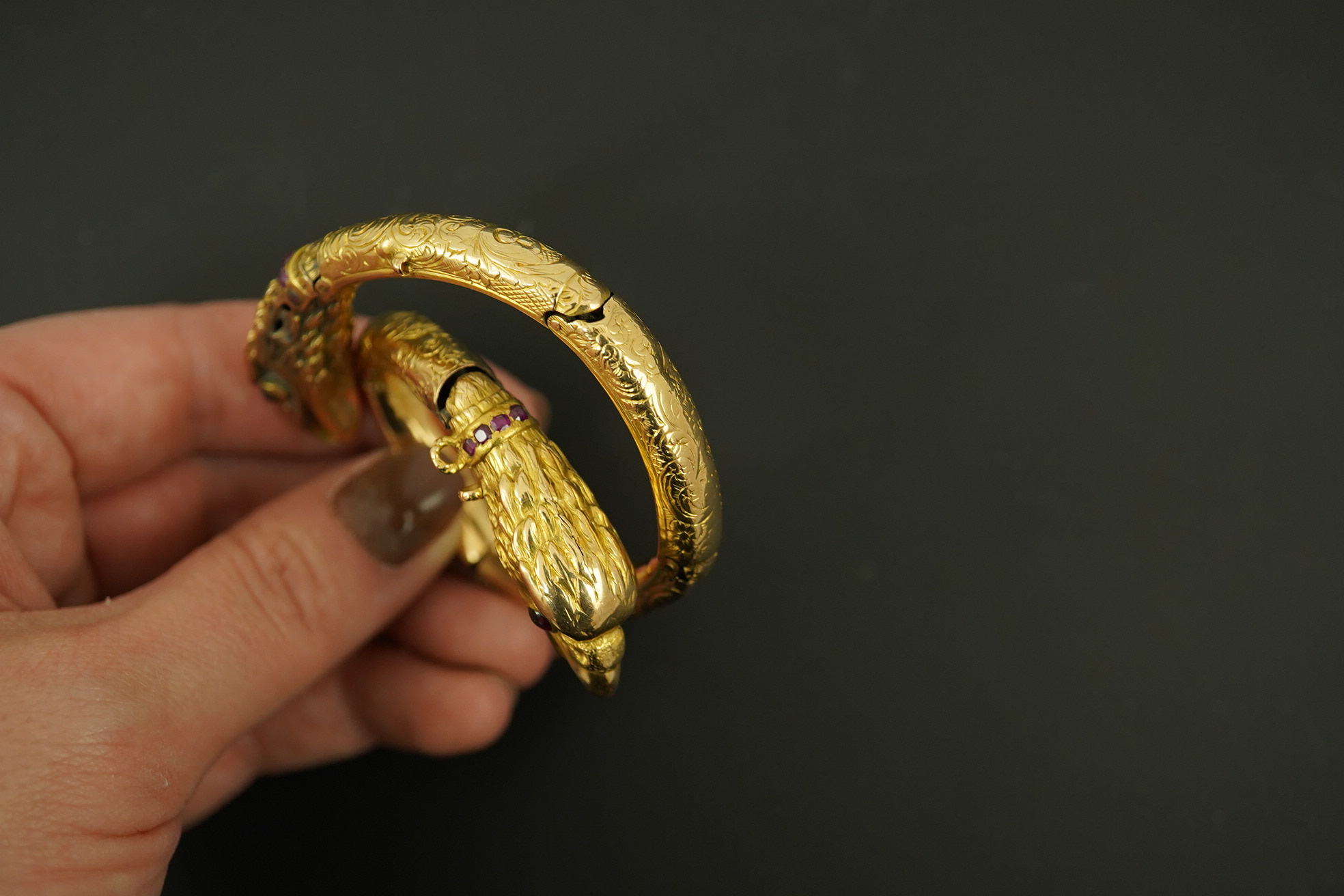 An antique Russian? engraved gold, garnet and ruby cluster set double headed eagle open hinged bracelet